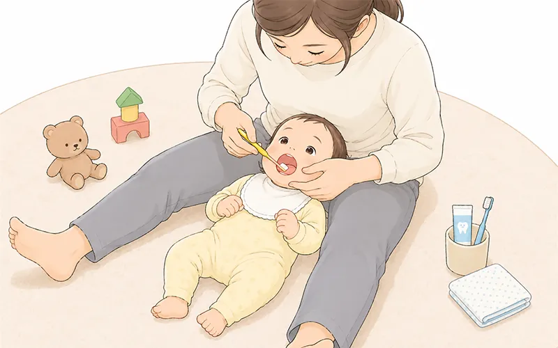 パパやママの膝の上で寝ながら仕上げ磨きをしてもらっているイメージ
